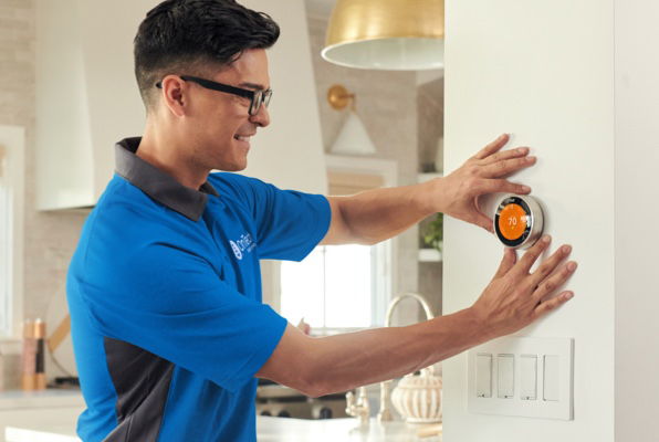 DISH Smart Home technician installing smart thermostat 